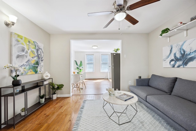 227 7th St, Jersey City, NJ 07302 - living area with light wood-type flooring, baseboards, and ceiling fan