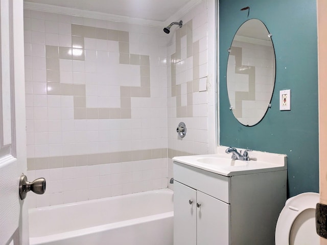 bathroom with ornamental molding, vanity, and tiled shower / bath combo