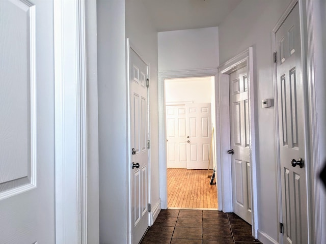 hall with dark tile patterned flooring