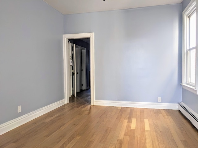 empty room featuring light hardwood / wood-style floors and baseboard heating