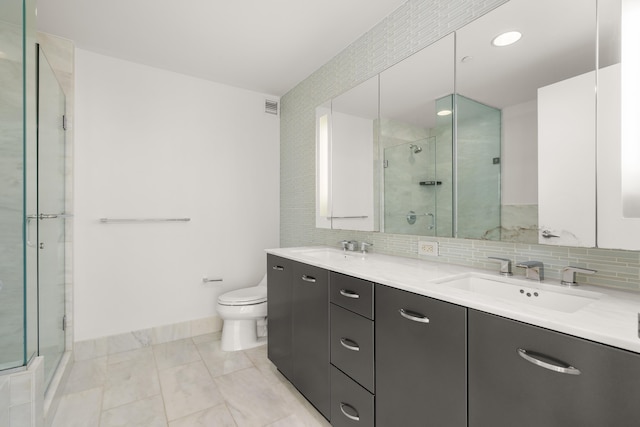 2 2nd St Unit 2106, Jersey City, NJ 07302 - bathroom with double vanity, a shower stall, toilet, and tasteful backsplash