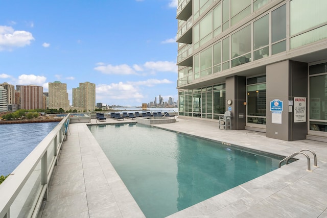 2 2nd St Unit 2106, Jersey City, NJ 07302 - view of pool with a skyline view, a pool with connected hot tub, and a water view