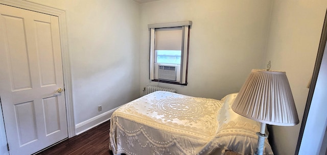 38 E 35th St, Bayonne, NJ 07002 - bedroom with dark wood-style flooring, radiator heating unit, baseboards, and cooling unit