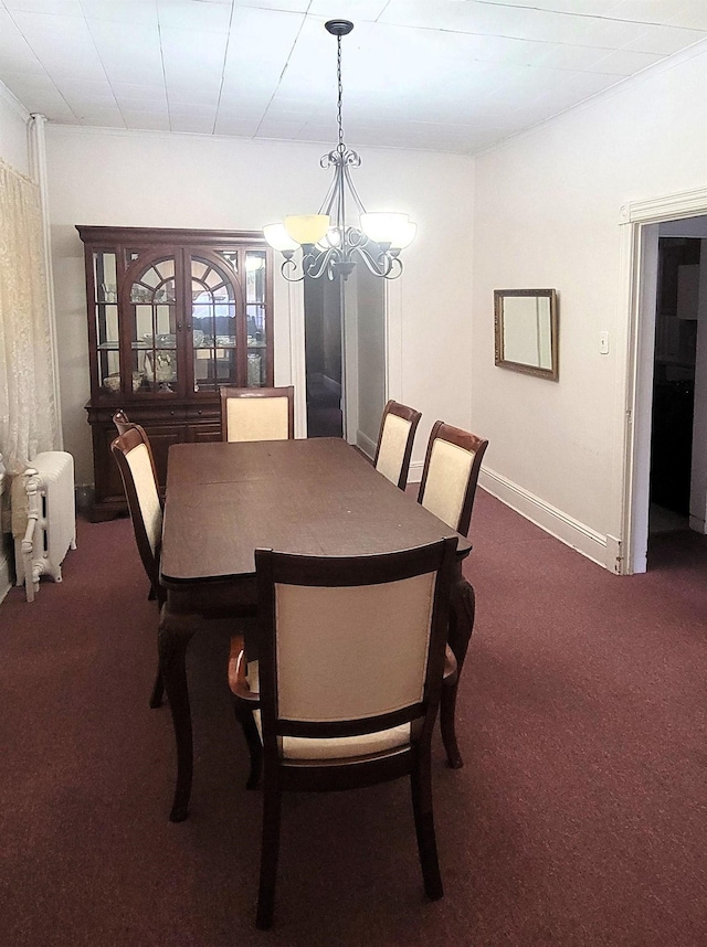 38 E 35th St, Bayonne, NJ 07002 - dining area with a chandelier, dark colored carpet, radiator heating unit, and baseboards