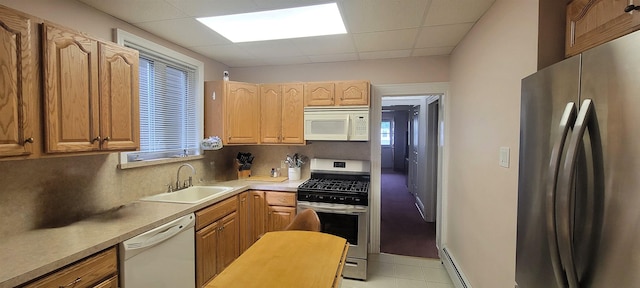 38 E 35th St, Bayonne, NJ 07002 - kitchen with stainless steel appliances, a sink, a paneled ceiling, decorative backsplash, and plenty of natural light
