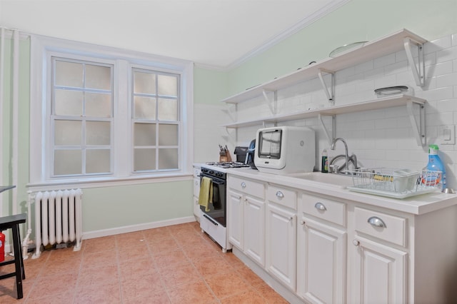 kitchen with a sink, ornamental molding, open shelves, radiator heating unit, and range with gas cooktop