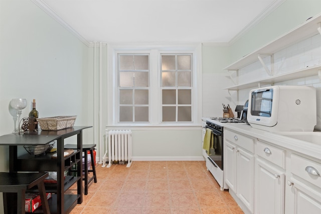 kitchen featuring open shelves, radiator, light countertops, ornamental molding, and gas stove