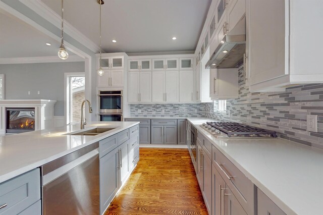 30 Cortland Pl, Cliffside Park, NJ 07010 - kitchen featuring decorative light fixtures, stainless steel appliances, a sink, light wood-type flooring, and under cabinet range hood