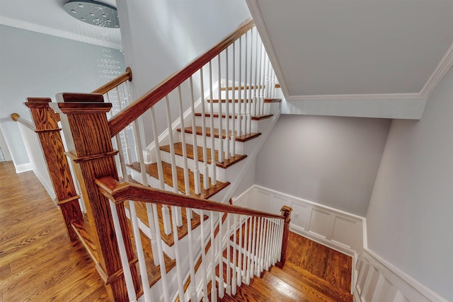 30 Cortland Pl, Cliffside Park, NJ 07010 - staircase featuring crown molding, wainscoting, a decorative wall, and wood finished floors