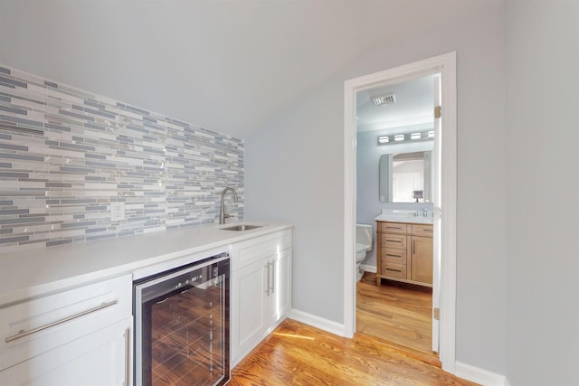 30 Cortland Pl, Cliffside Park, NJ 07010 - bar with wine cooler, light wood-style flooring, a sink, visible vents, and backsplash