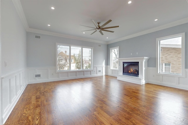 unfurnished living room featuring recessed lighting, visible vents, a ceiling fan, a glass covered fireplace, and wood finished floors