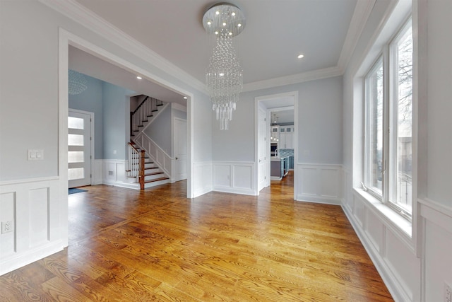 30 Cortland Pl, Cliffside Park, NJ 07010 - unfurnished room featuring a healthy amount of sunlight, stairway, light wood-type flooring, and a notable chandelier