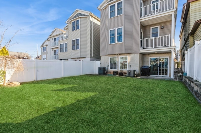 back of property featuring a yard and central AC