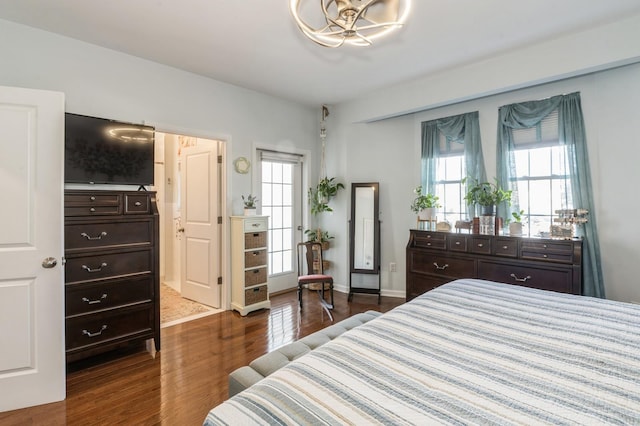 bedroom featuring multiple windows and dark wood-type flooring