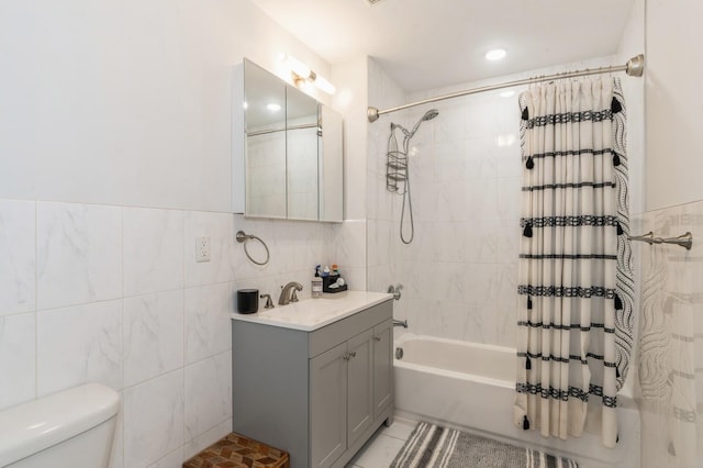 full bathroom featuring tile walls, vanity, toilet, and shower / bath combo with shower curtain