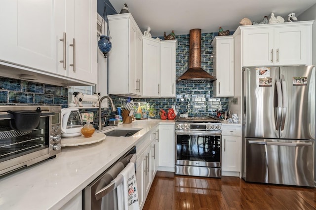 kitchen featuring stainless steel appliances, white cabinets, a sink, and wall chimney exhaust hood