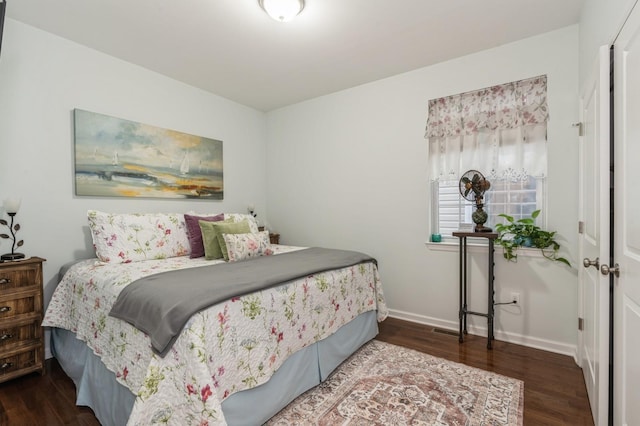 bedroom with dark hardwood / wood-style floors