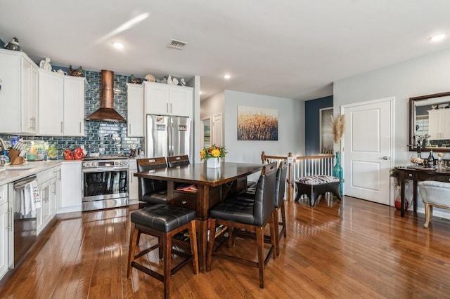 dining area with wood-type flooring and sink