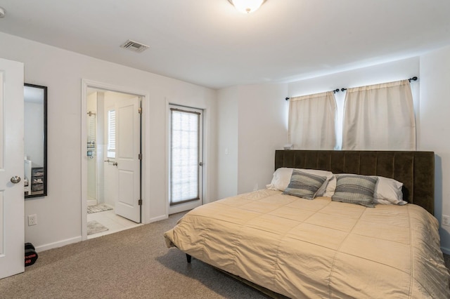 bedroom featuring light carpet and ensuite bath