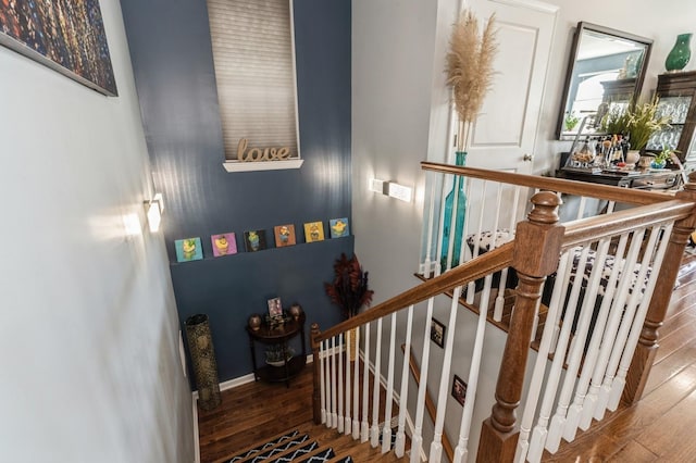 stairs featuring hardwood / wood-style flooring