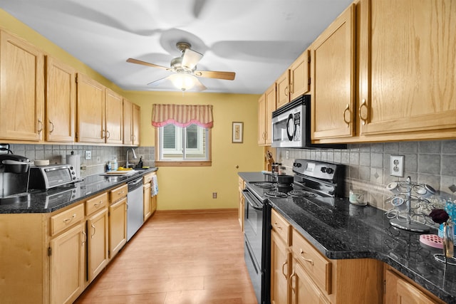 kitchen featuring tasteful backsplash, light brown cabinets, appliances with stainless steel finishes, and light wood-style flooring