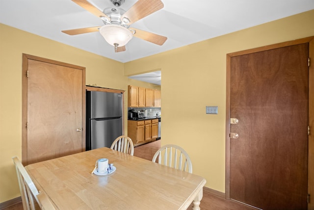 dining room featuring ceiling fan and baseboards