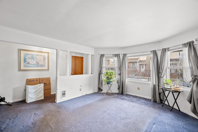 spare room featuring carpet flooring and baseboards