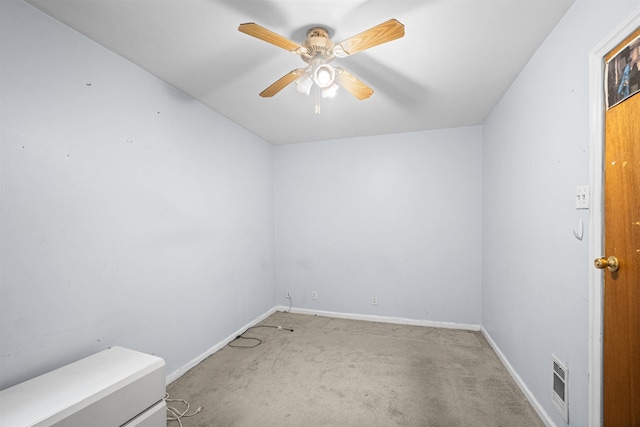 carpeted empty room featuring baseboards, visible vents, and a ceiling fan