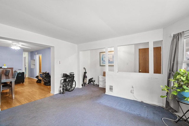 interior space with visible vents, ceiling fan, and carpet flooring