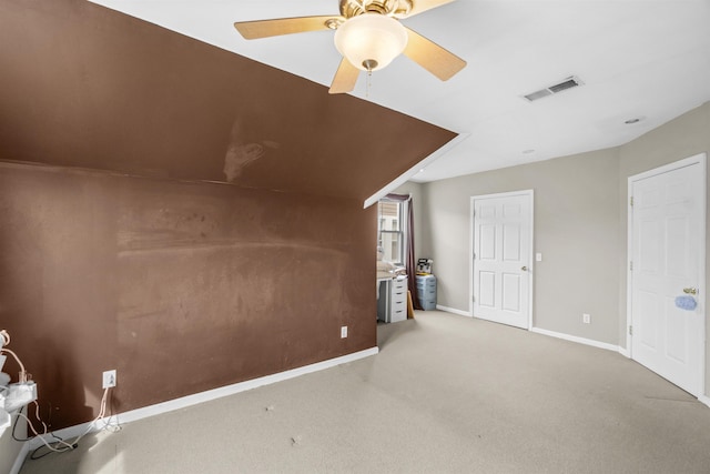 additional living space featuring light carpet, baseboards, visible vents, and ceiling fan