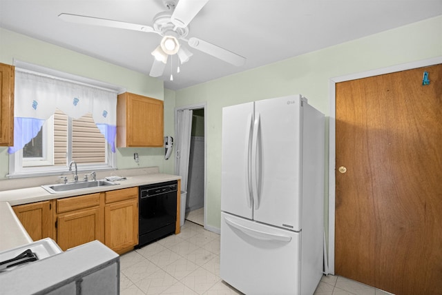 kitchen with a ceiling fan, dishwasher, freestanding refrigerator, light countertops, and a sink