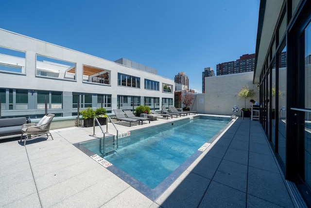 view of swimming pool with a patio area