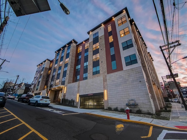 view of outdoor building at dusk