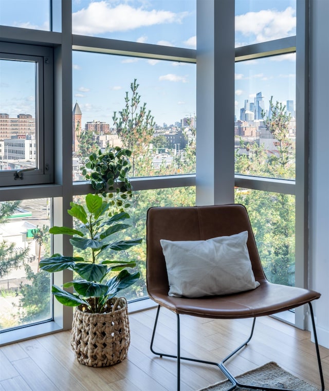 234 10th St Unit 606, Jersey City, NJ 07302 - sitting room featuring a skyline view, baseboard heating, and wood finished floors