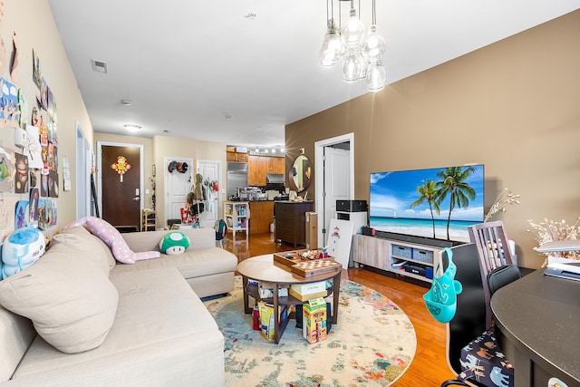 living room featuring light wood-style floors and visible vents