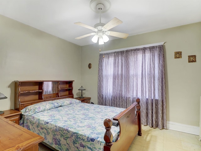 bedroom with ceiling fan and baseboards