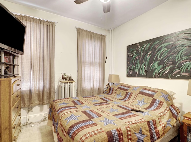 tiled bedroom with radiator and a ceiling fan