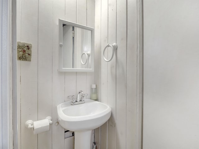 bathroom featuring wood walls