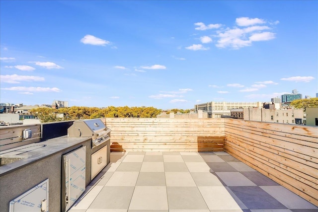 view of patio / terrace featuring area for grilling and a grill