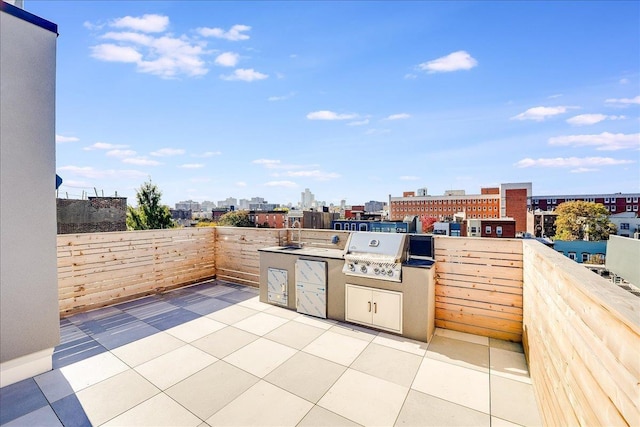 view of patio with an outdoor kitchen and grilling area