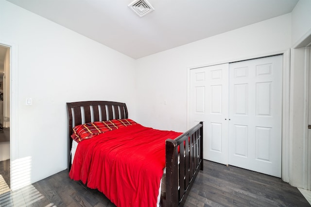 bedroom featuring dark hardwood / wood-style flooring and a closet