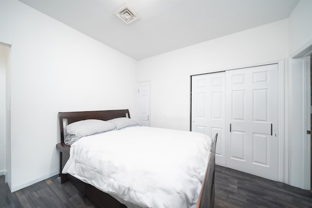 bedroom featuring dark hardwood / wood-style flooring and a closet