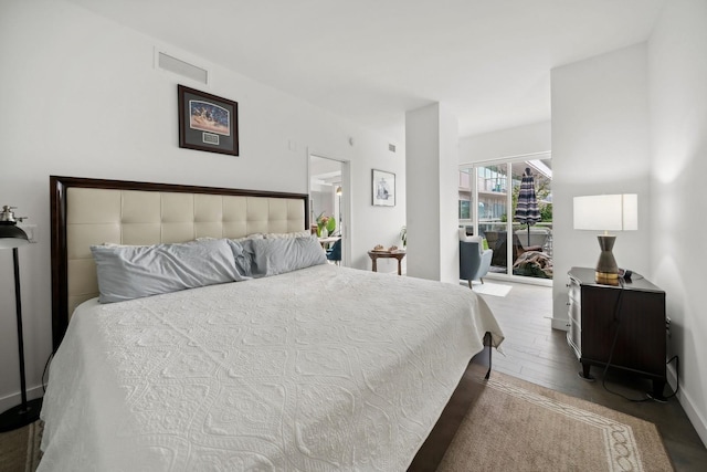 bedroom featuring hardwood / wood-style flooring and access to outside