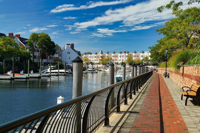 dock area with a water view and a residential view