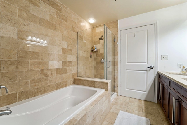 full bathroom featuring a stall shower, tile patterned flooring, vanity, and a bath