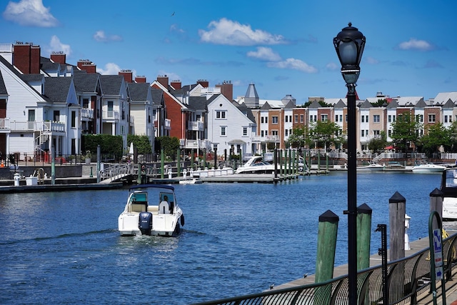 water view featuring a dock and a residential view