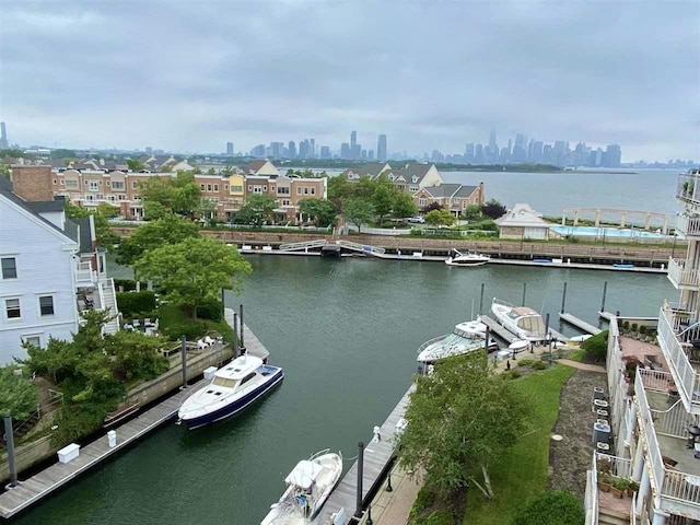 water view with a boat dock and a view of city