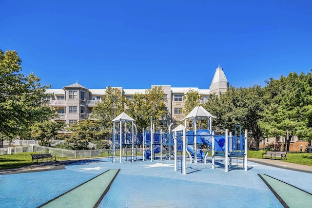 view of property's community featuring playground community and fence