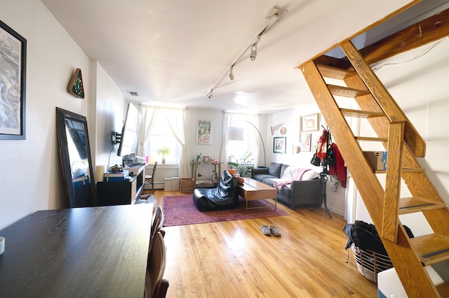 living room featuring light hardwood / wood-style floors and track lighting