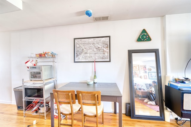 dining area with hardwood / wood-style flooring